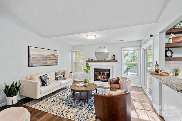 3308 Selwyn Farms Ln Unit 5, Charlotte, NC 28209 - living room with light wood-style floors, a glass covered fireplace, and a dry bar
