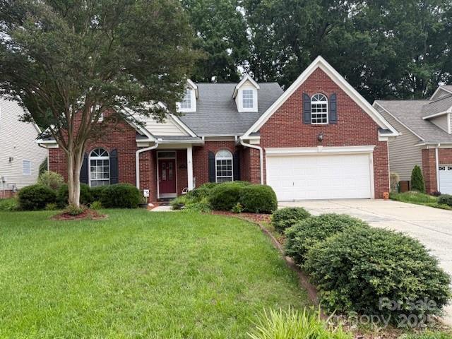 9419 Olivia Ln, Charlotte, NC 28277 - view of front of property featuring brick siding, driveway, a front lawn, and an attached garage