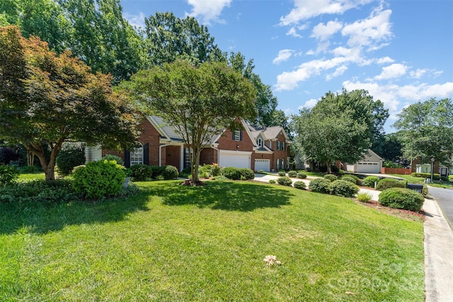 9419 Olivia Ln, Charlotte, NC 28277 - obstructed view of property featuring a garage, brick siding, and a front lawn