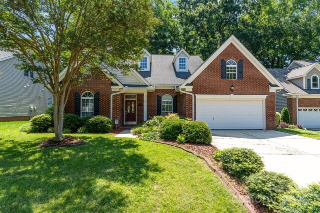 9419 Olivia Ln, Charlotte, NC 28277 - traditional-style house with driveway, brick siding, a front lawn, and a garage