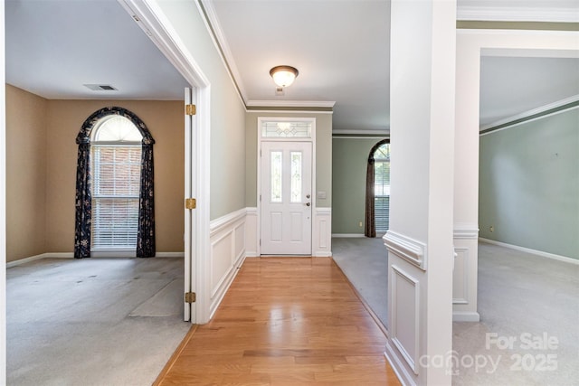 9419 Olivia Ln, Charlotte, NC 28277 - entrance foyer featuring ornamental molding, light carpet, and light wood finished floors