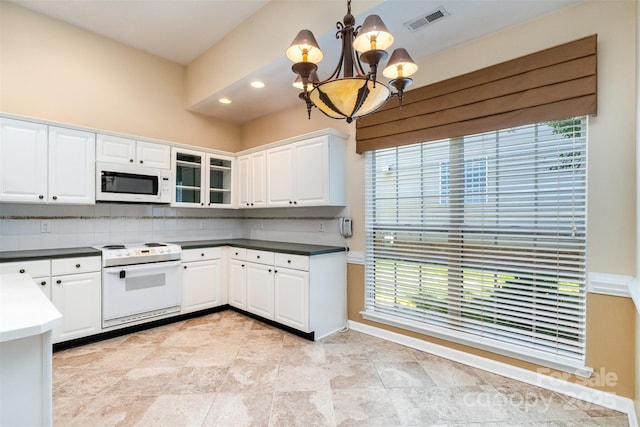 9419 Olivia Ln, Charlotte, NC 28277 - kitchen featuring white appliances, a chandelier, decorative backsplash, white cabinetry, and pendant lighting
