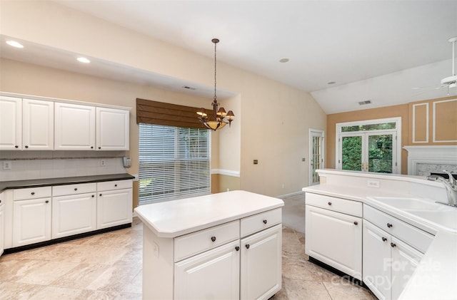 9419 Olivia Ln, Charlotte, NC 28277 - kitchen featuring vaulted ceiling, a chandelier, hanging light fixtures, white cabinets, and a center island