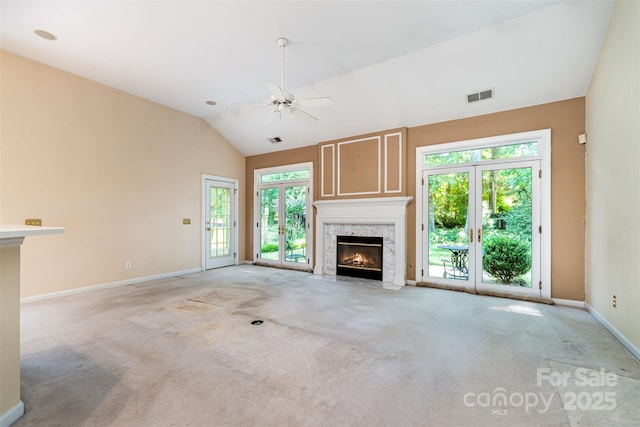 9419 Olivia Ln, Charlotte, NC 28277 - unfurnished living room featuring a fireplace, light carpet, vaulted ceiling, and a ceiling fan