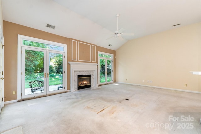 9419 Olivia Ln, Charlotte, NC 28277 - unfurnished living room featuring plenty of natural light, ceiling fan, vaulted ceiling, a fireplace, and light colored carpet