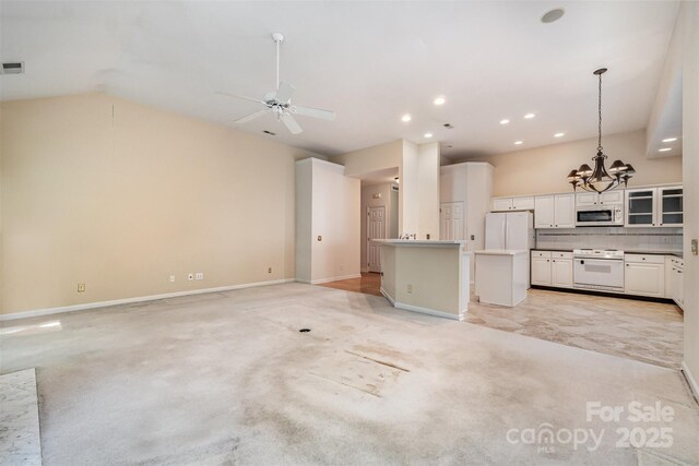 9419 Olivia Ln, Charlotte, NC 28277 - unfurnished living room with light colored carpet, a chandelier, recessed lighting, ceiling fan, and vaulted ceiling