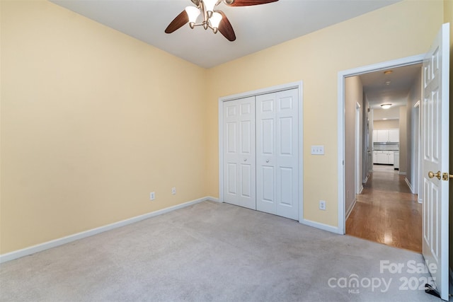 9419 Olivia Ln, Charlotte, NC 28277 - unfurnished bedroom featuring light carpet, a closet, and a ceiling fan