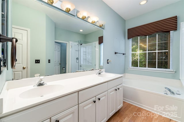 9419 Olivia Ln, Charlotte, NC 28277 - full bathroom featuring a shower stall, a bath, double vanity, wood finished floors, and recessed lighting