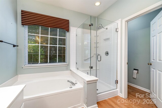 9419 Olivia Ln, Charlotte, NC 28277 - bathroom featuring a bath, a stall shower, wood finished floors, vanity, and recessed lighting