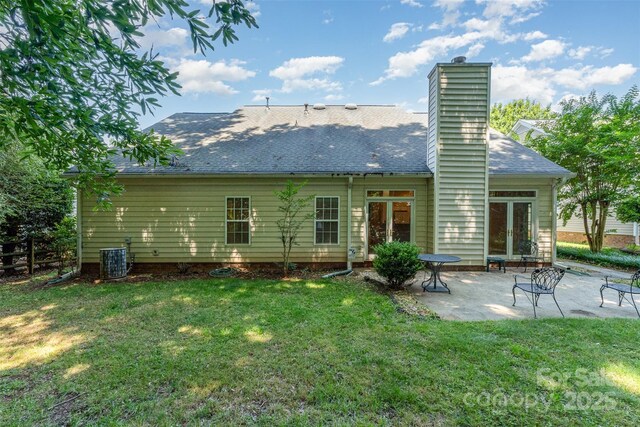 9419 Olivia Ln, Charlotte, NC 28277 - back of property with a patio area, a lawn, a chimney, and roof with shingles