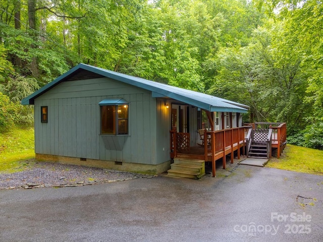 302 Mitchell Rd, Sylva, NC 28779 - chalet / cabin featuring crawl space, a view of trees, and a wooden deck