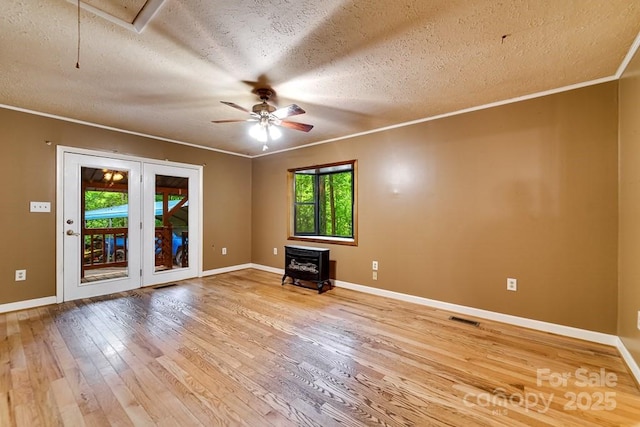 302 Mitchell Rd, Sylva, NC 28779 - empty room featuring light wood-style floors, a textured ceiling, ornamental molding, a ceiling fan, and baseboards