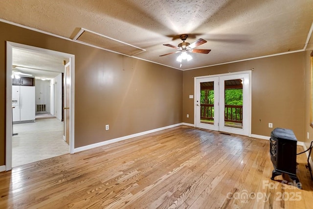 302 Mitchell Rd, Sylva, NC 28779 - unfurnished room with attic access, light wood-style flooring, a textured ceiling, a ceiling fan, and baseboards