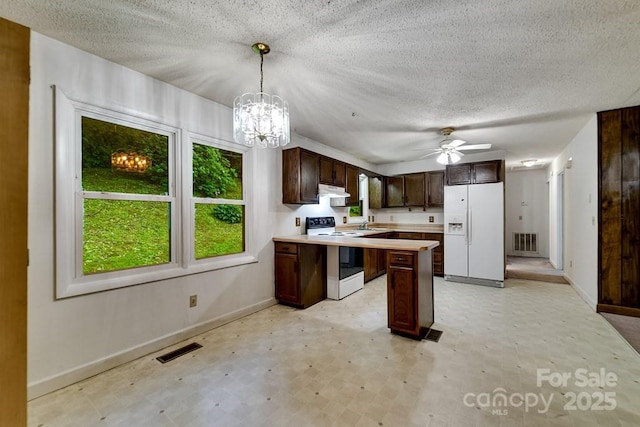 302 Mitchell Rd, Sylva, NC 28779 - kitchen with white appliances, light flooring, baseboards, under cabinet range hood, and light countertops
