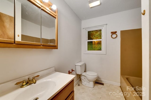 302 Mitchell Rd, Sylva, NC 28779 - bathroom featuring vanity, toilet, a tub, baseboards, and tile patterned floors