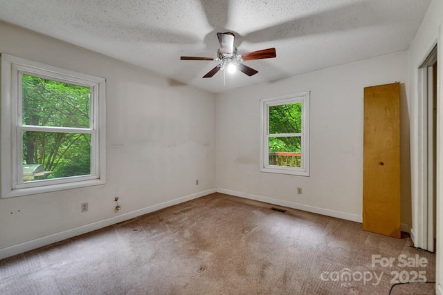 302 Mitchell Rd, Sylva, NC 28779 - unfurnished bedroom featuring carpet floors, baseboards, a textured ceiling, and a ceiling fan