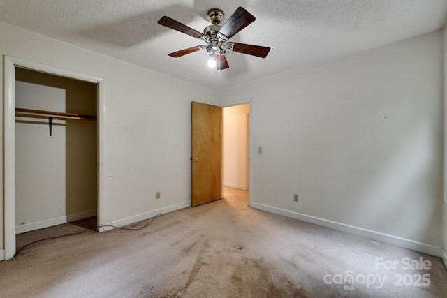 302 Mitchell Rd, Sylva, NC 28779 - unfurnished bedroom featuring baseboards, carpet, a closet, a textured ceiling, and a ceiling fan