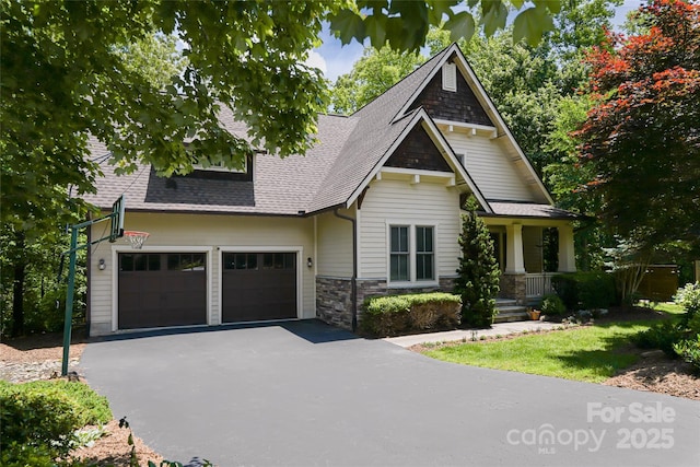1 E Owl Creek Ln, Fairview, NC 28730 - craftsman-style house with a garage, a shingled roof, driveway, and stone siding