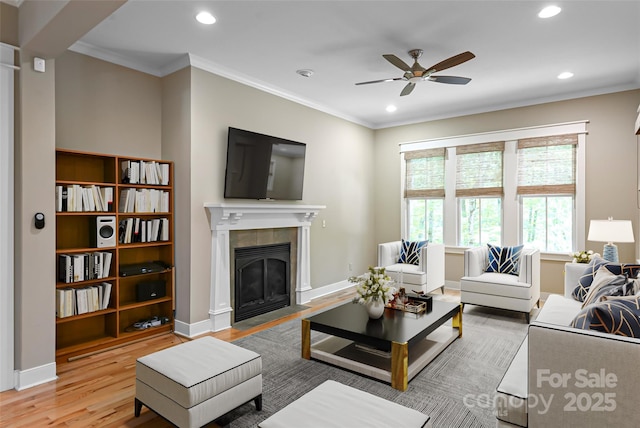 1 E Owl Creek Ln, Fairview, NC 28730 - living area featuring a ceiling fan, recessed lighting, light wood finished floors, a tiled fireplace, and ornamental molding