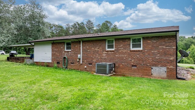 1691 Hill River Rd, Hiddenite, NC 28636 - rear view of house featuring central air condition unit, a lawn, brick siding, and crawl space