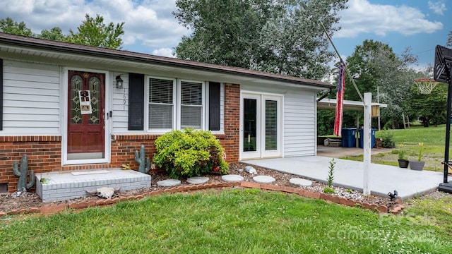 1691 Hill River Rd, Hiddenite, NC 28636 - exterior space with brick siding, a lawn, and a patio