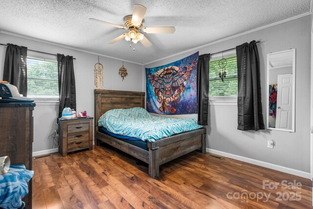1691 Hill River Rd, Hiddenite, NC 28636 - bedroom featuring a textured ceiling, multiple windows, crown molding, wood finished floors, and baseboards