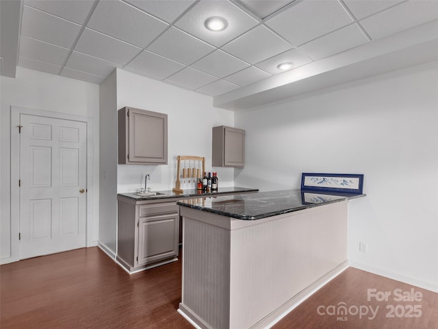 6 Lakeway Cir, Weaverville, NC 28787 - kitchen with gray cabinets, a peninsula, dark wood-style flooring, a drop ceiling, and a sink