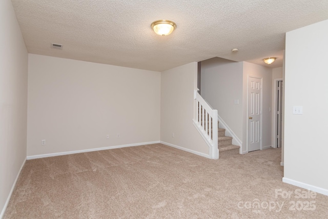 10548 English Setter Way, Charlotte, NC 28269 - carpeted spare room featuring stairs, a textured ceiling, and baseboards