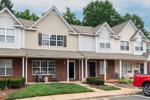 10548 English Setter Way, Charlotte, NC 28269 - multi unit property with a porch, brick siding, and roof with shingles