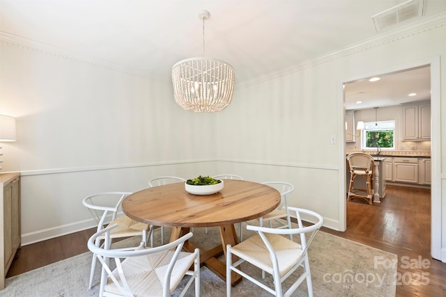 7022 Lancer Dr, Charlotte, NC 28226 - dining space featuring wood finished floors, a chandelier, and crown molding
