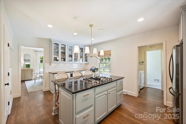 7022 Lancer Dr, Charlotte, NC 28226 - kitchen featuring freestanding refrigerator, gas stovetop, glass insert cabinets, plenty of natural light, and recessed lighting