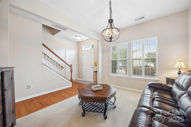444 Battery Cir, Clover, SC 29710 - carpeted living area with stairway, a chandelier, and wood finished floors