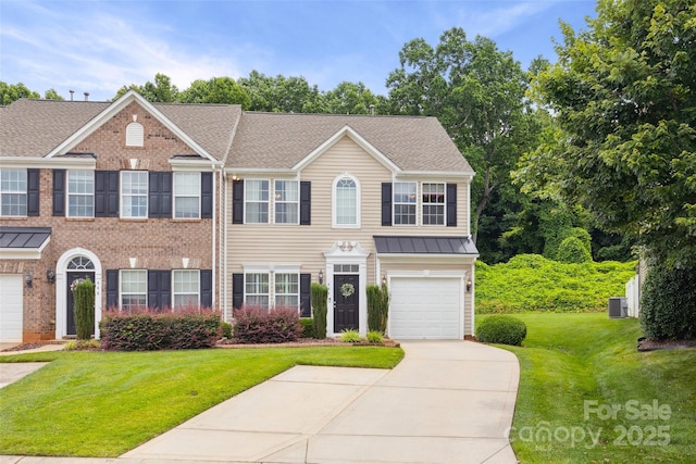 444 Battery Cir, Clover, SC 29710 - view of front of property featuring concrete driveway, a front yard, brick siding, a garage, and a standing seam roof