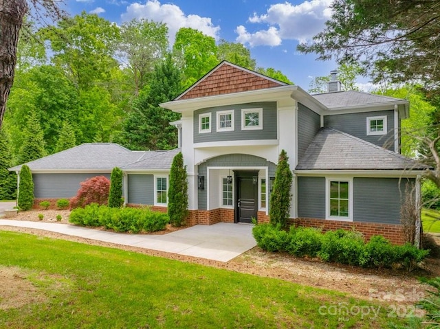 74 Eastmoor Dr, Asheville, NC 28805 - view of front of house with brick siding, a front lawn, and a chimney