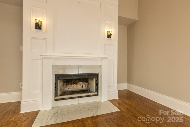 74 Eastmoor Dr, Asheville, NC 28805 - detailed view of baseboards, a high end fireplace, and wood finished floors