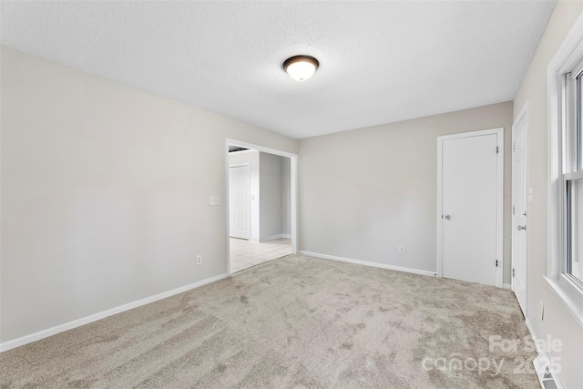 1606 Northwoods Dr, Kings Mountain, NC 28086 - spare room featuring carpet, a textured ceiling, and baseboards