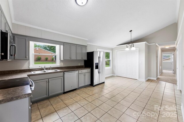 1606 Northwoods Dr, Kings Mountain, NC 28086 - kitchen with appliances with stainless steel finishes, a sink, gray cabinetry, dark countertops, and vaulted ceiling