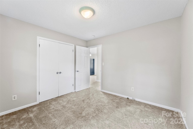1606 Northwoods Dr, Kings Mountain, NC 28086 - unfurnished bedroom featuring carpet, baseboards, a closet, and a textured ceiling