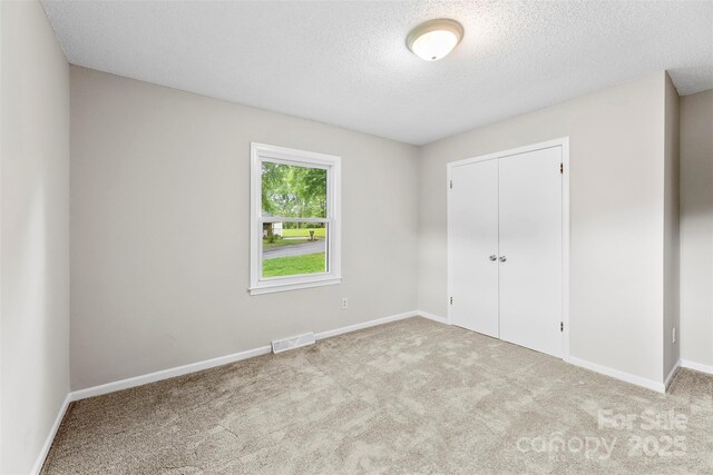 1606 Northwoods Dr, Kings Mountain, NC 28086 - unfurnished bedroom with a textured ceiling, carpet floors, a closet, and baseboards