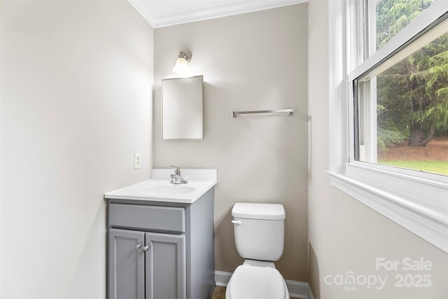 1606 Northwoods Dr, Kings Mountain, NC 28086 - half bath with toilet, vanity, plenty of natural light, and crown molding