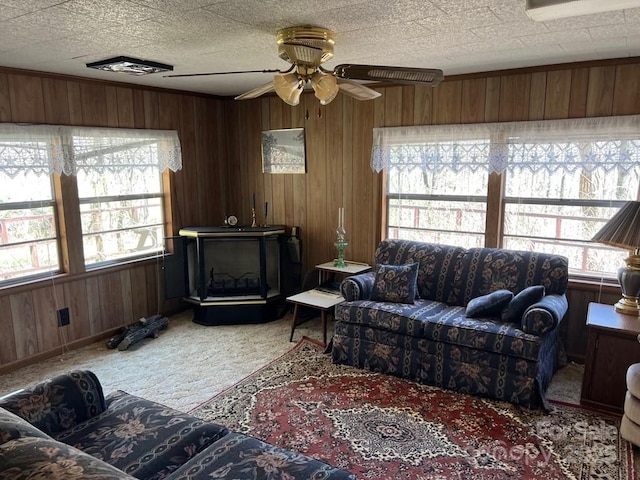 239 Laurel Dr, Whittier, NC 28789 - living area with light colored carpet, plenty of natural light, wooden walls, and a ceiling fan