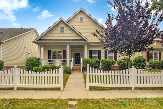 1006 Phar Lap Dr, Indian Trail, NC 28079 - view of front facade with covered porch, a fenced front yard, and roof with shingles