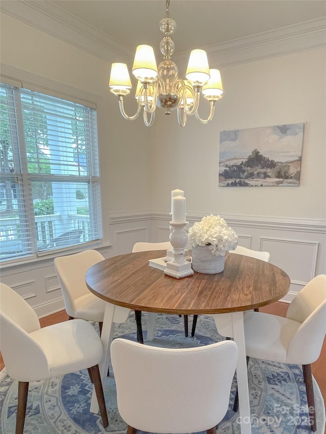 1006 Phar Lap Dr, Indian Trail, NC 28079 - dining room with a chandelier, a decorative wall, crown molding, and wainscoting