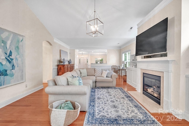 1006 Phar Lap Dr, Indian Trail, NC 28079 - living area with a chandelier, crown molding, arched walkways, and light wood-type flooring