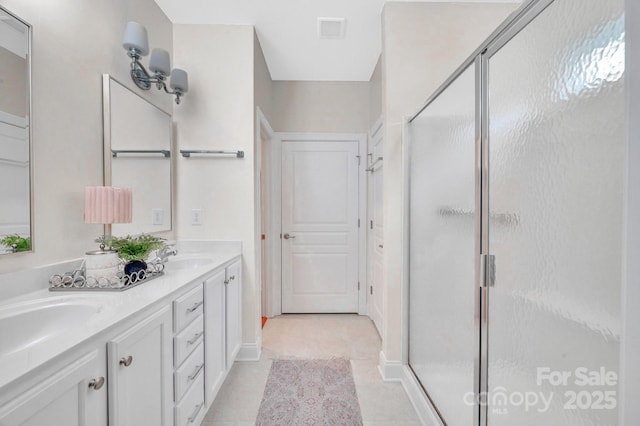 1006 Phar Lap Dr, Indian Trail, NC 28079 - bathroom featuring double vanity, a stall shower, baseboards, and tile patterned flooring