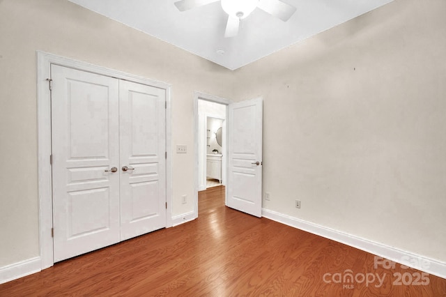 1006 Phar Lap Dr, Indian Trail, NC 28079 - unfurnished bedroom with wood finished floors, baseboards, a closet, and a ceiling fan
