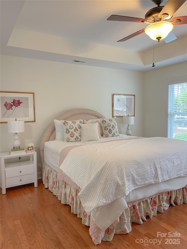 1006 Phar Lap Dr, Indian Trail, NC 28079 - bedroom with a raised ceiling, wood finished floors, and a ceiling fan