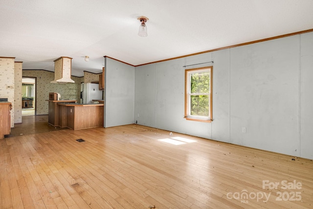 501 Deer Chase Cir, Cedar Mountain, NC 28718 - unfurnished living room with light wood finished floors, crown molding, and lofted ceiling