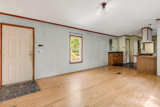 501 Deer Chase Cir, Cedar Mountain, NC 28718 - unfurnished living room featuring hardwood / wood-style flooring and crown molding