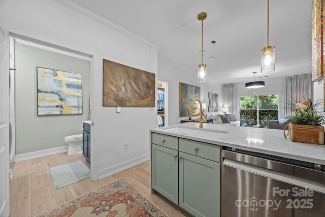 630 Calvert St Unit 111, Charlotte, NC 28208 - kitchen with dishwasher, a sink, green cabinetry, light wood-type flooring, and baseboards